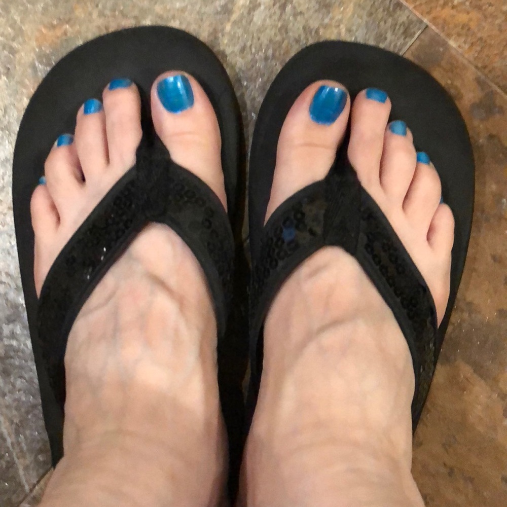 Black sequined flip flops.